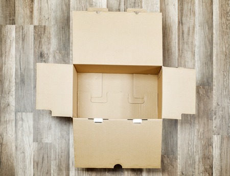 Big opened box on the wooden floor