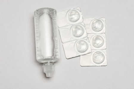 Contact lens solution and contact lens packages aon a white background