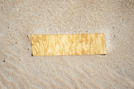 Wooden plank on sand at the beach in summer. Top view.の写真素材