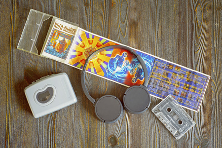 VILNIUS, LITHUANIA - SEPTEMBER 18, 2018: Retro walkman, Kula Shaker - K 1996 cassete and headphones on the wooden tableのeditorial素材