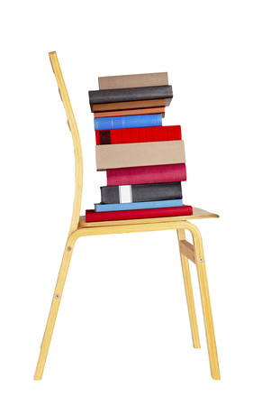 Colorful books on wooden chair isolated on white background.の写真素材