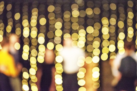 Shiny yellow christmas lights glowing at night. Christmas background.