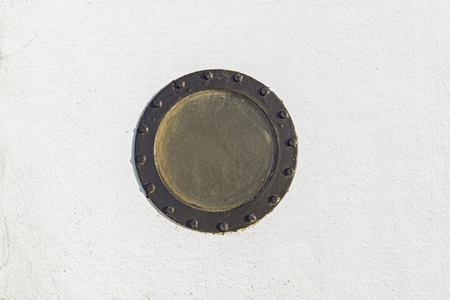 Sailboat porthole in white grunge metal wallの写真素材