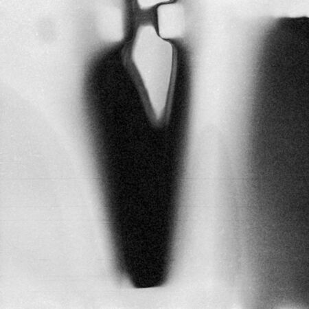 Black and white textured background with light leaks and grain
