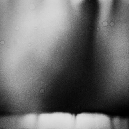 Black and white textured background with light leaks and grain