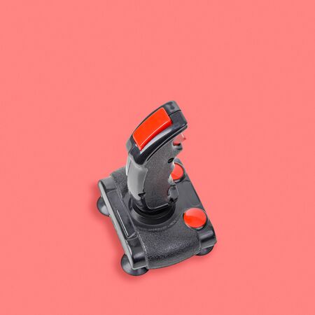 Retro computer gaming controller isolated on pink background. Color of the year 2019 - Living Coralの写真素材