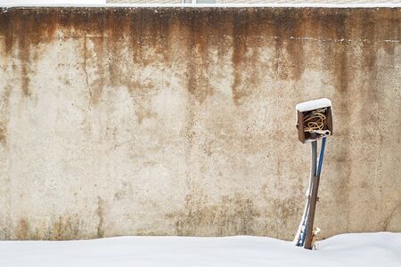 abandoned grunge house with electrical equipment near the wall in winterの写真素材