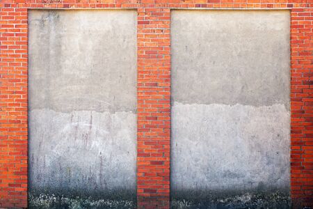 weathered stucco wall and red brick frame around.の写真素材