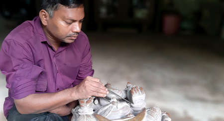 BHUBANESWAR, ODISHA, INDIA,NOVEMBER 2019 - Carving stone, craftsman shaping stone, art and craftsのeditorial素材