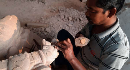 BHUBANESWAR, ODISHA, INDIA,NOVEMBER 2019- Carving stone, craftsman shaping stone, art and craftsのeditorial素材