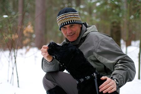 Reinforcing good behaviour on a winter's walk with a doggy treat.