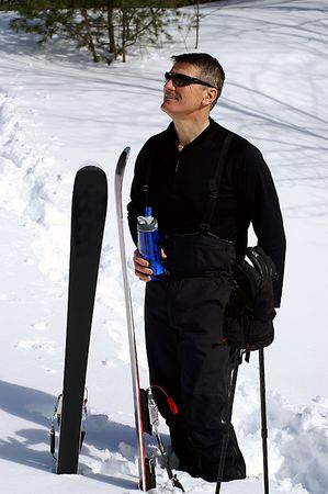 A man with a bottle of water when skiingの写真素材