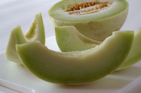 The Honeydew Melon belongs to the same group of plants as cucumbers, pumkins and gourds. Cultivated since Egyptian times, melons remain a delicious and cooling treat on a hot day.の写真素材