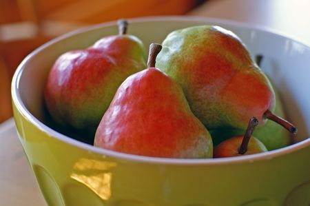 Colourful Pears in old-fashioned bowlの写真素材