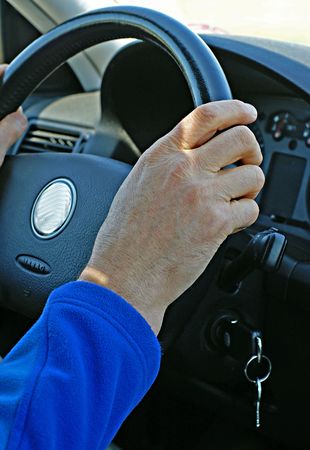 A responsible driver behind the steering wheel of a carの写真素材
