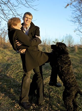 Baby Boomers Having Fun with Portuguese Water Dog の写真素材