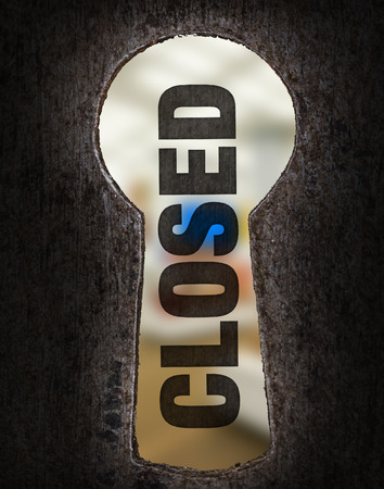 Keyhole from wooden door with text sign sorry we are closedの写真素材