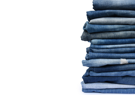 Stack different blue pants, with jeans texture isolated on white background.の写真素材