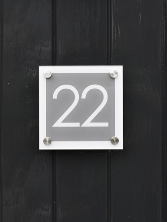 House number 22 on wooden wall happy new home moving away modern by number twenty twoの写真素材