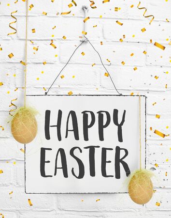 Happy easter text quote on sign board with confetti and eggs Easter decorationの写真素材