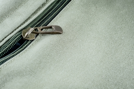 iron zip on green fabricの写真素材