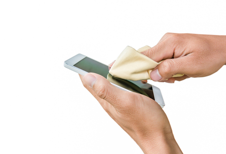 hand cleaning touch screen mobile phone on white backgroundの写真素材