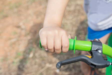 Child Hand on Bicycle Handlebarの写真素材