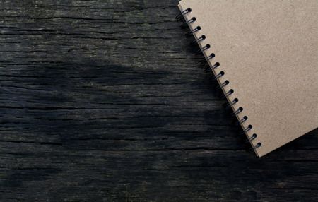 brown notebook on wood texture backgroundの写真素材