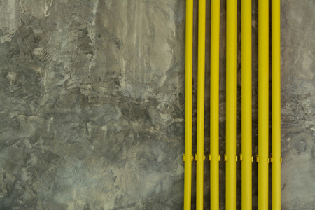 Yellow Pipe on Loft Grunge Wall Texture Backgroundの写真素材