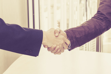 The two businessmen shake hands after successfully doing business.の写真素材