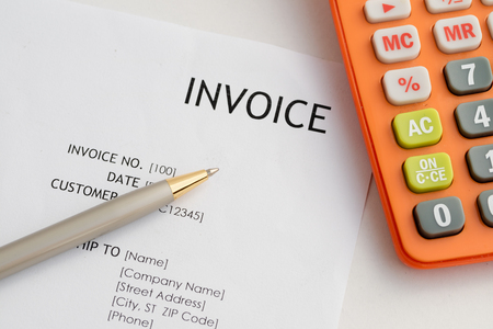 Invoice letter head with pen and calculator / selective focus