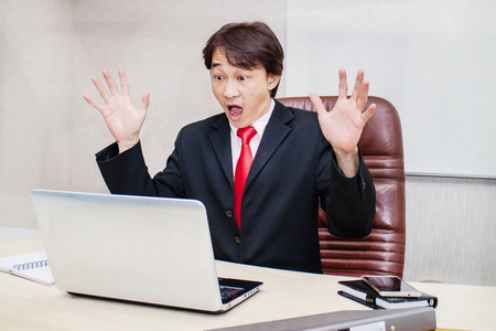 Asian businessman Shocked by what happened in his notebook.の写真素材