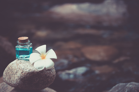 Gel bath with plumeria or frangipani on blur waterfallの写真素材