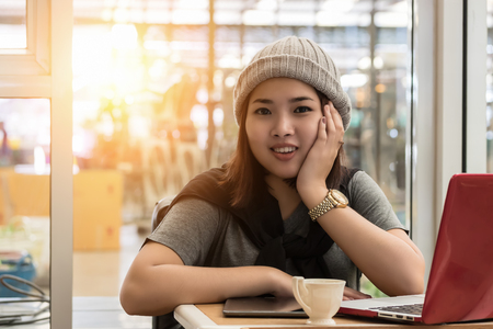 Young woman relaxing with a notebook. in the living roomの写真素材