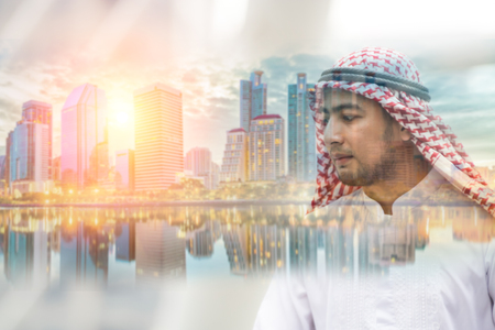 Double exposure of Arab man and Cityscape and sunset at evening time.for business concept background