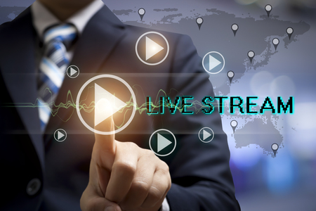 A Businessman are touching screen interface and select live stream.の写真素材