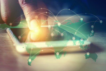 Double exposure of hand touch screen smartphone  and world map with marketing online concept