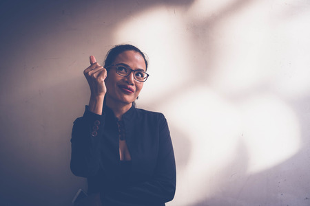 Business women standing side wall in eveningの写真素材