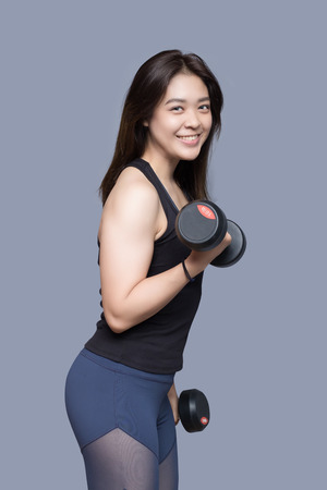 Fitness and Sport. Athletic woman doing exercises in the gym.の写真素材