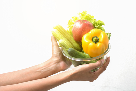 Woman hand and vegetables on white backgroundの写真素材