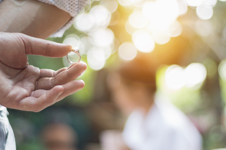 Young man holding a diamond ring for a girlfriend's weddingの写真素材