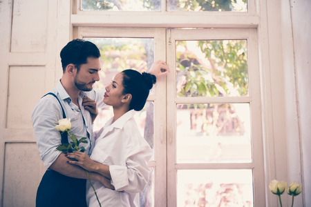 Couple standing by the window in the morning.の写真素材