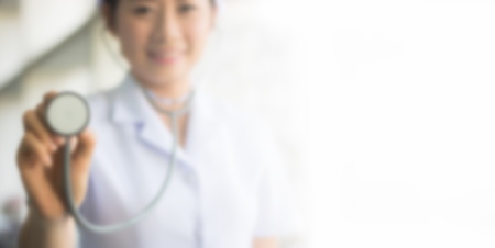 Blurred image of nurses are using stethoscope heart for background designの写真素材