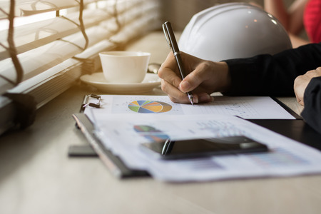 Business people hand writing on business reportの写真素材