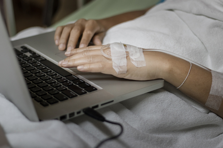 Sick people are using the notebook.の写真素材