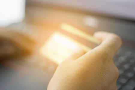 Hands holding credit card and online shopping in laptop.  shopping.ecommerce concept selective...