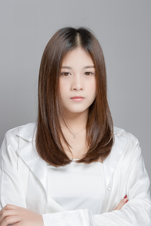 Asian woman on a gray backgroundの写真素材