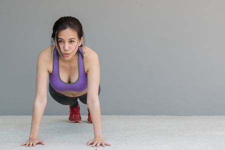 young beautiful woman in sportswear doing plankingの写真素材