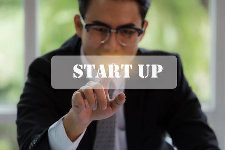 Businessman pushing start up button for business concept with technology element and ecommerce concept.の写真素材