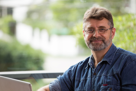 Portrait of smiling elderly man are smiling and hapy in green background.の写真素材
